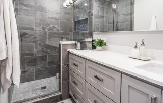 Denton Texas, Denton contractor, Denton renovation, Denton remodeler, bathroom remodel, bathroom renovation, bathroom before and after, can lighting, LED lighting, hexagon tile, 12x24 tile, custom shower, shower glass, custom cabinets, quartz, small space layout, brushed nickel hardware, shampoo niche, linen tower, mudroom
